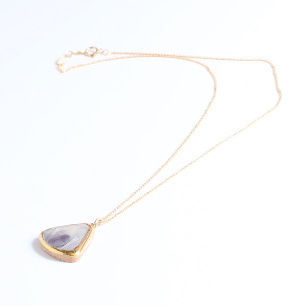 Necklace with a teardrop-shaped pendant on a white background