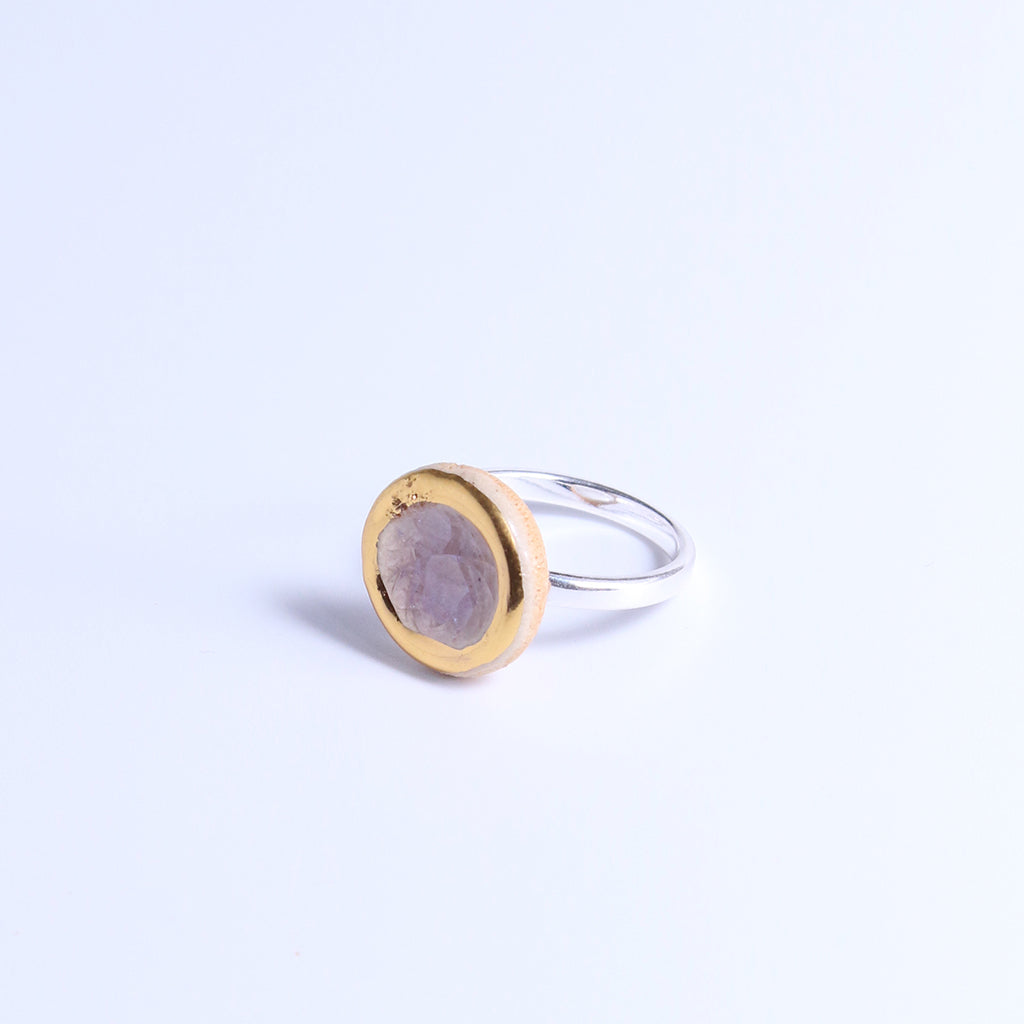 Ring with gold and silver design on a white background