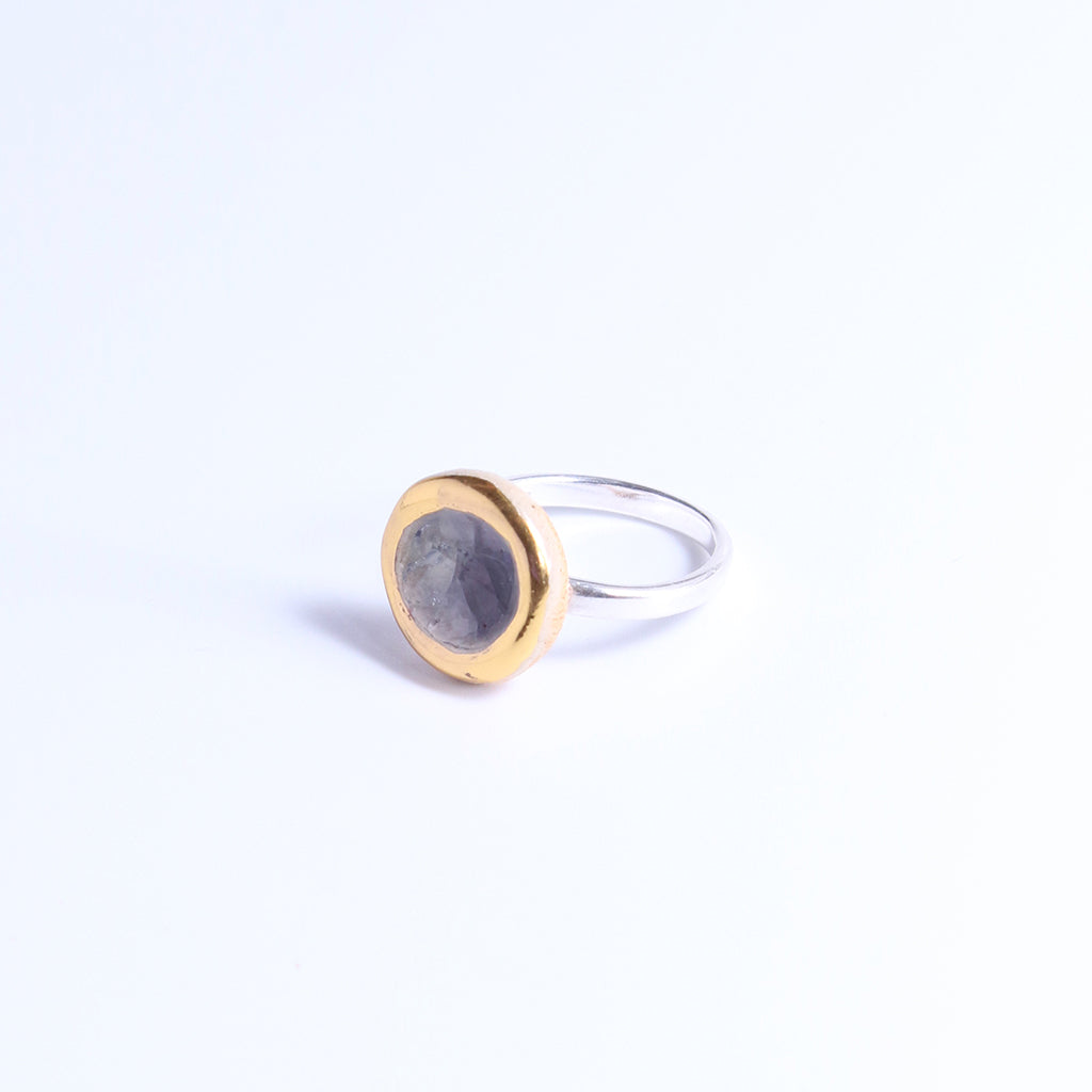 Silver ring band with a ceramic and glass charm in size small. The charm features smoky-purple coloured glass and gold lustre detailing around its outer edge. 