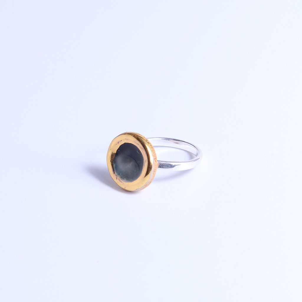 Ring with gold and silver design on a light  background
