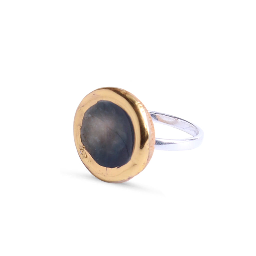 Ring with gold and silver design on a white background