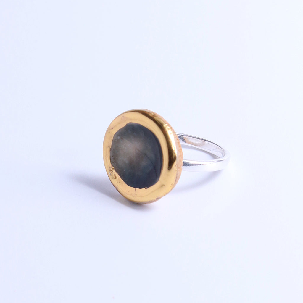 Ring with gold and silver design on a light background