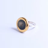 Ring with gold and silver design on a light background