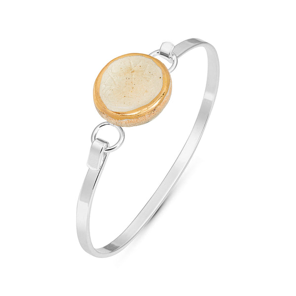Side view crystal clear crackled glass round charm outlined in gold lustre on a silver plated latch bangle