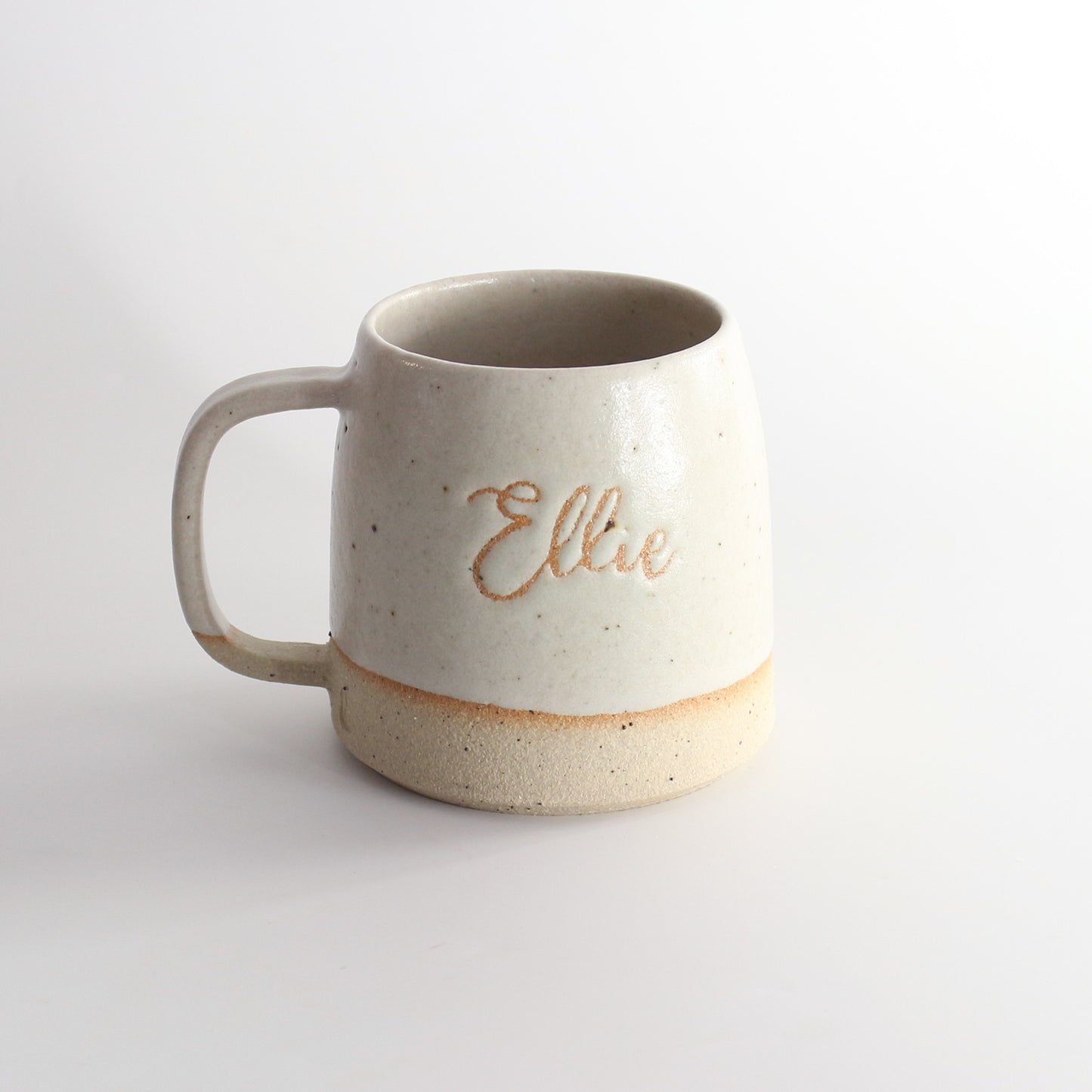Handmade stoneware mug with personalised name design with the name 'Ellie' in our off-white glaze