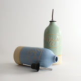 Green and blue personalised oil pourers, blue on its side