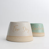 Top Dog bowl in white next to personalised green dog bowl