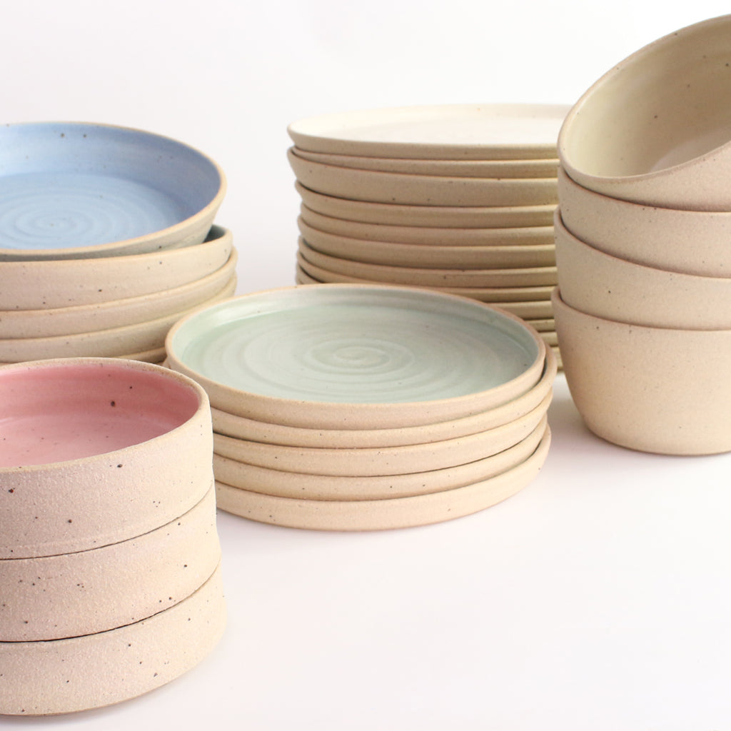Stacks of pastel side plates, bowls, dinner plates and nibbles bowls