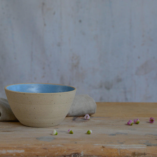 Close up of flecked stoneware and blue glaze in bowl