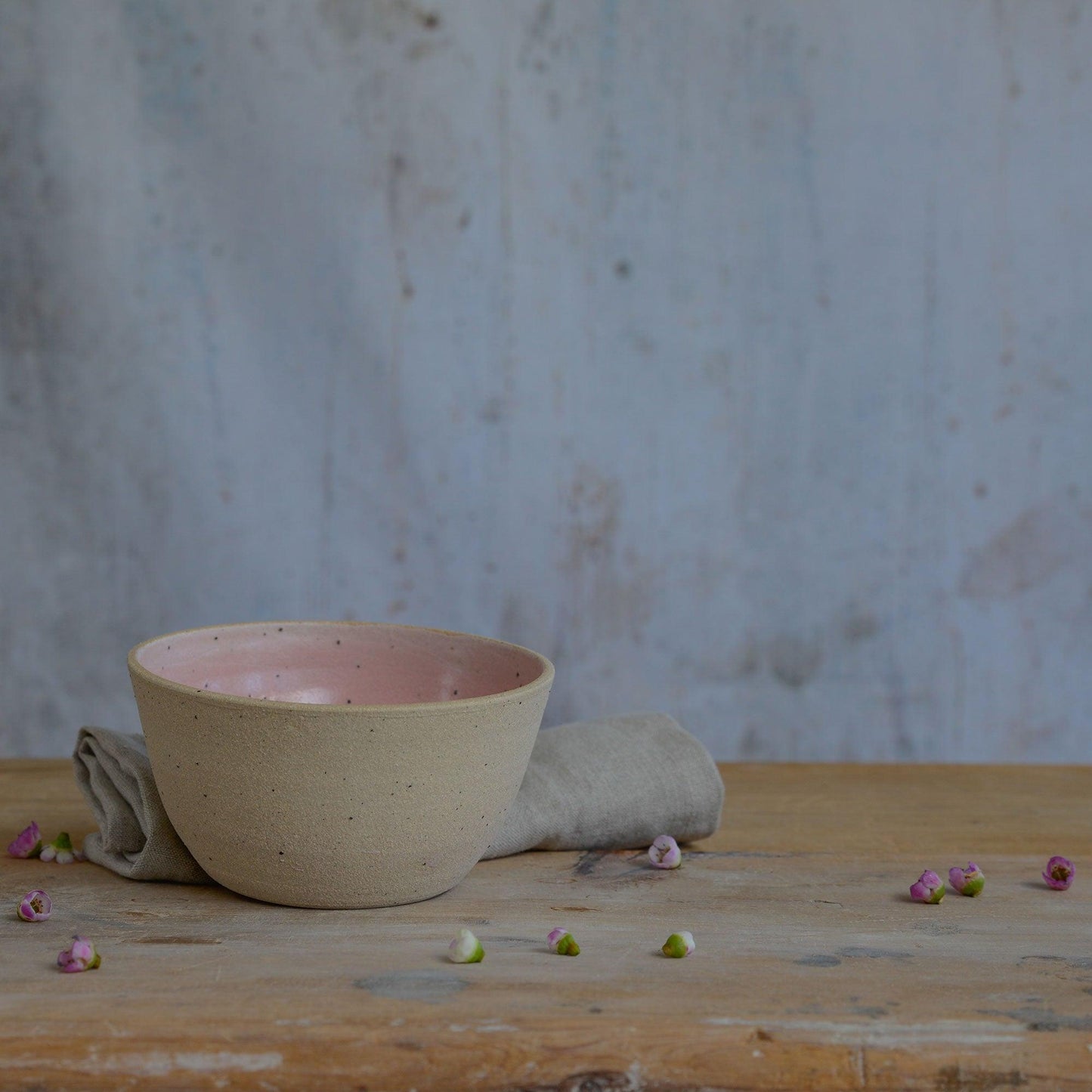 Flecked stoneware and pink glaze details of bowl on table