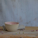 Flecked stoneware and pink glaze details of bowl on table