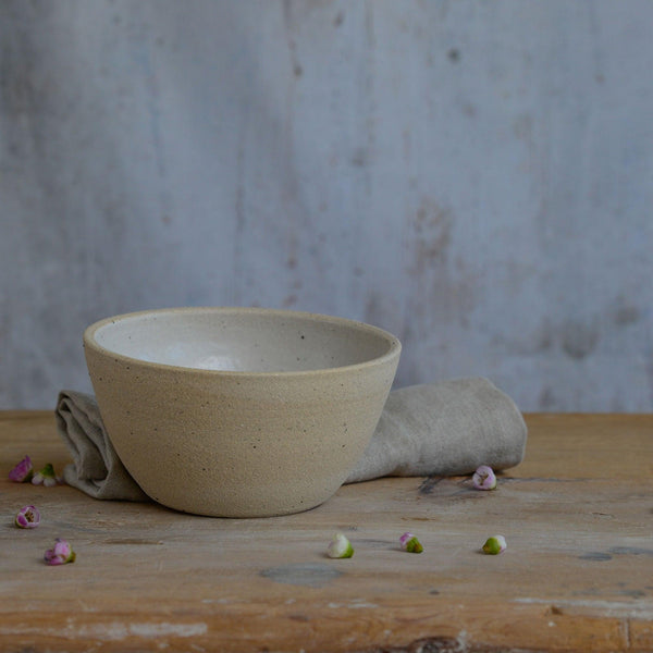 Close up of flecked stoneware and white glaze on bowl