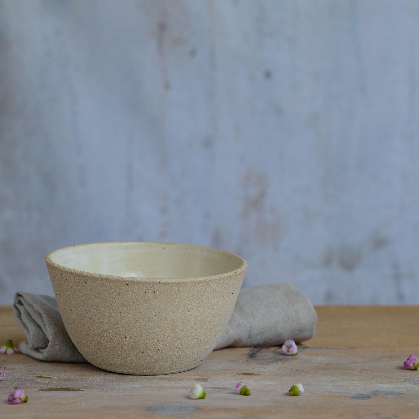 Close up of flecked stoneware and yellow glaze on bowl