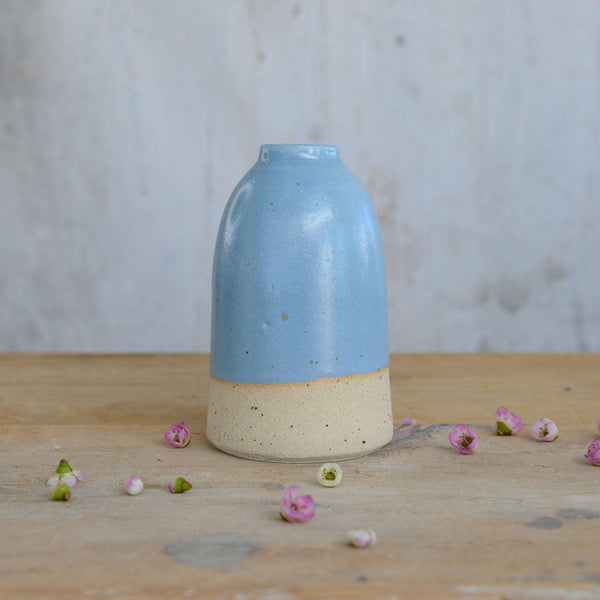 Close up of flecked stoneware and blue glaze on vase