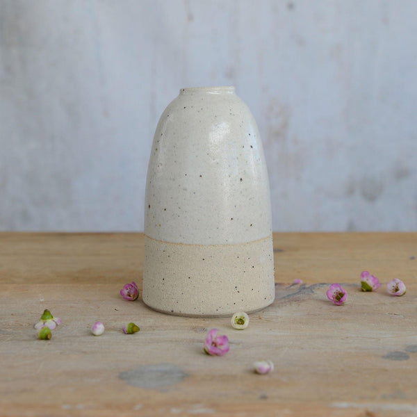 Close up of flecked stoneware and white glaze on medium vase