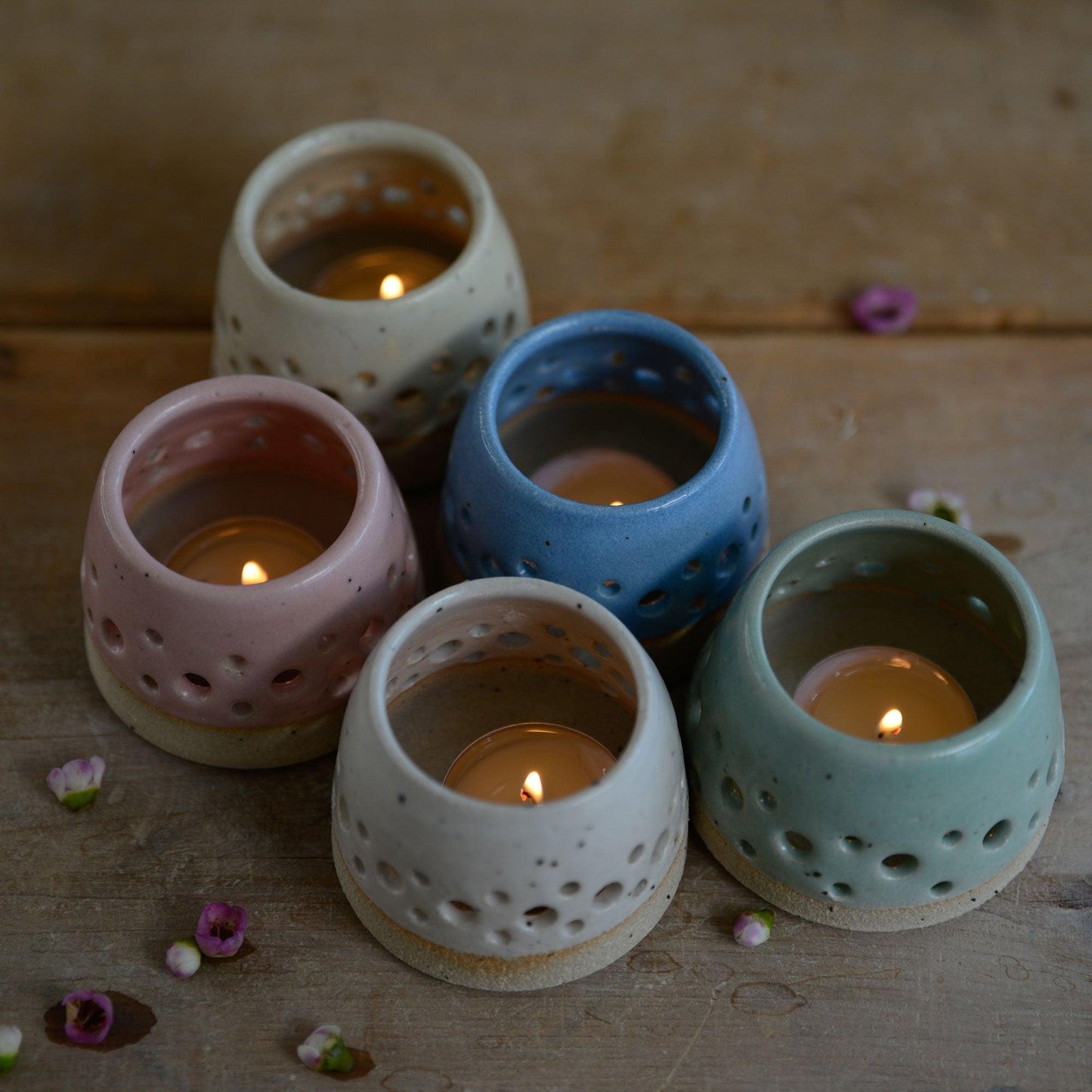 Above view of lit pastel tealight holders