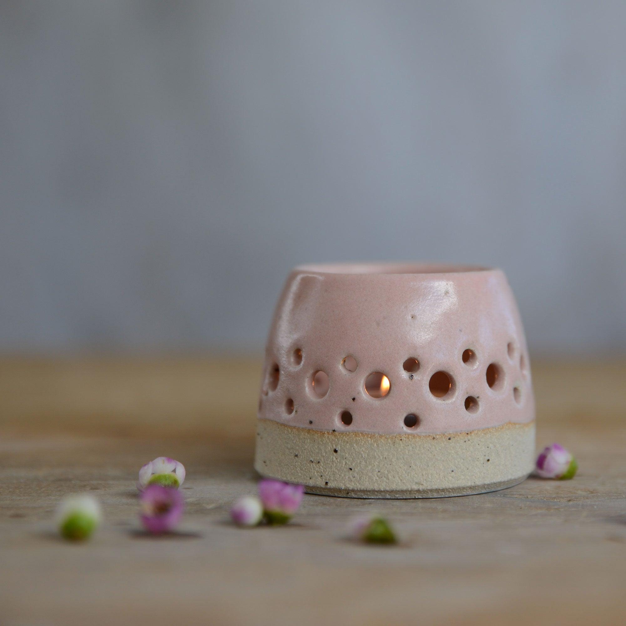 Close up of flecked stoneware and pink glaze on tealight holder
