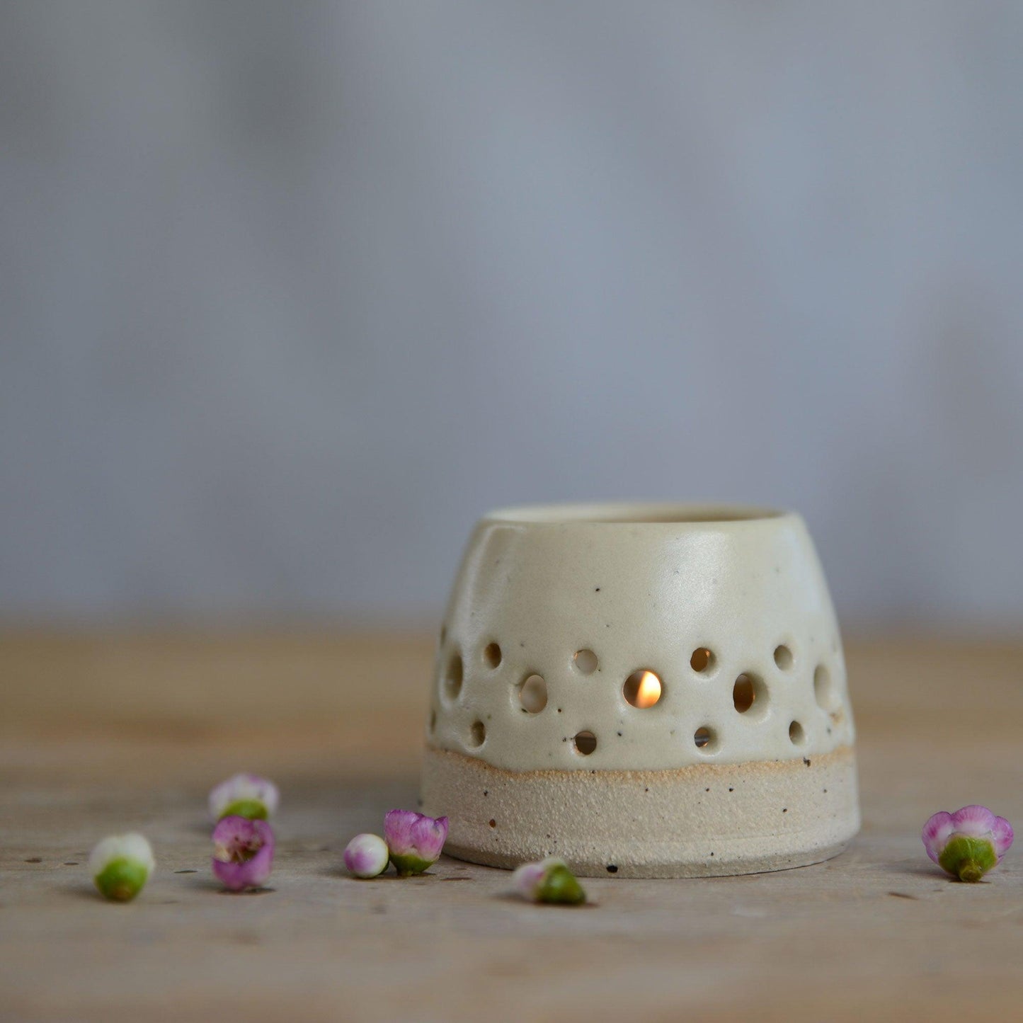 Close up of flecked stoneware and yellow glaze on tealight