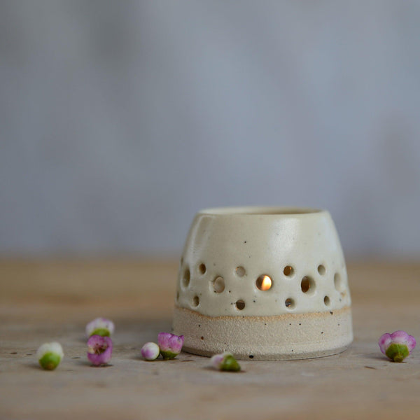 Close up of flecked stoneware and yellow glaze on tealight