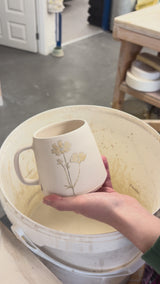 Video showing the process of glazing our birth flower mugs