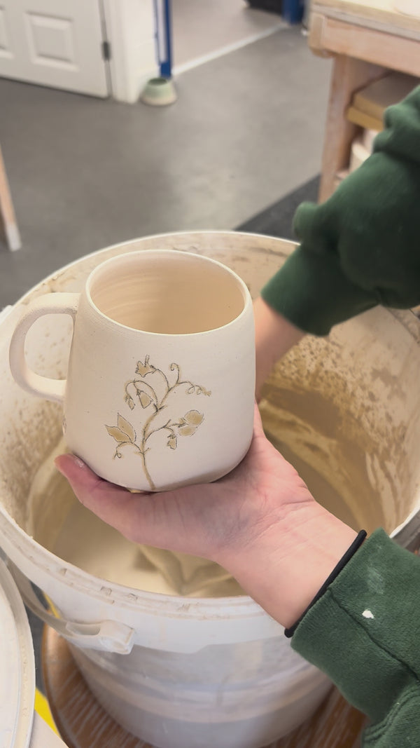 Video showing the process of glazing our birth flower mugs
