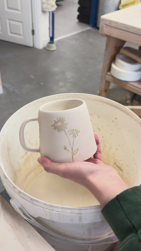 Video showing the process of glazing our birth flower mugs