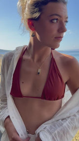 Video showing model wearing our Dusk drop pendant combining clay, glass with smoky purple tones and gold lustre and on a gold fill chain, paired with teardrop earrings in the same style. 