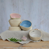 Stacked pastel herb shredder bowls on different levels
