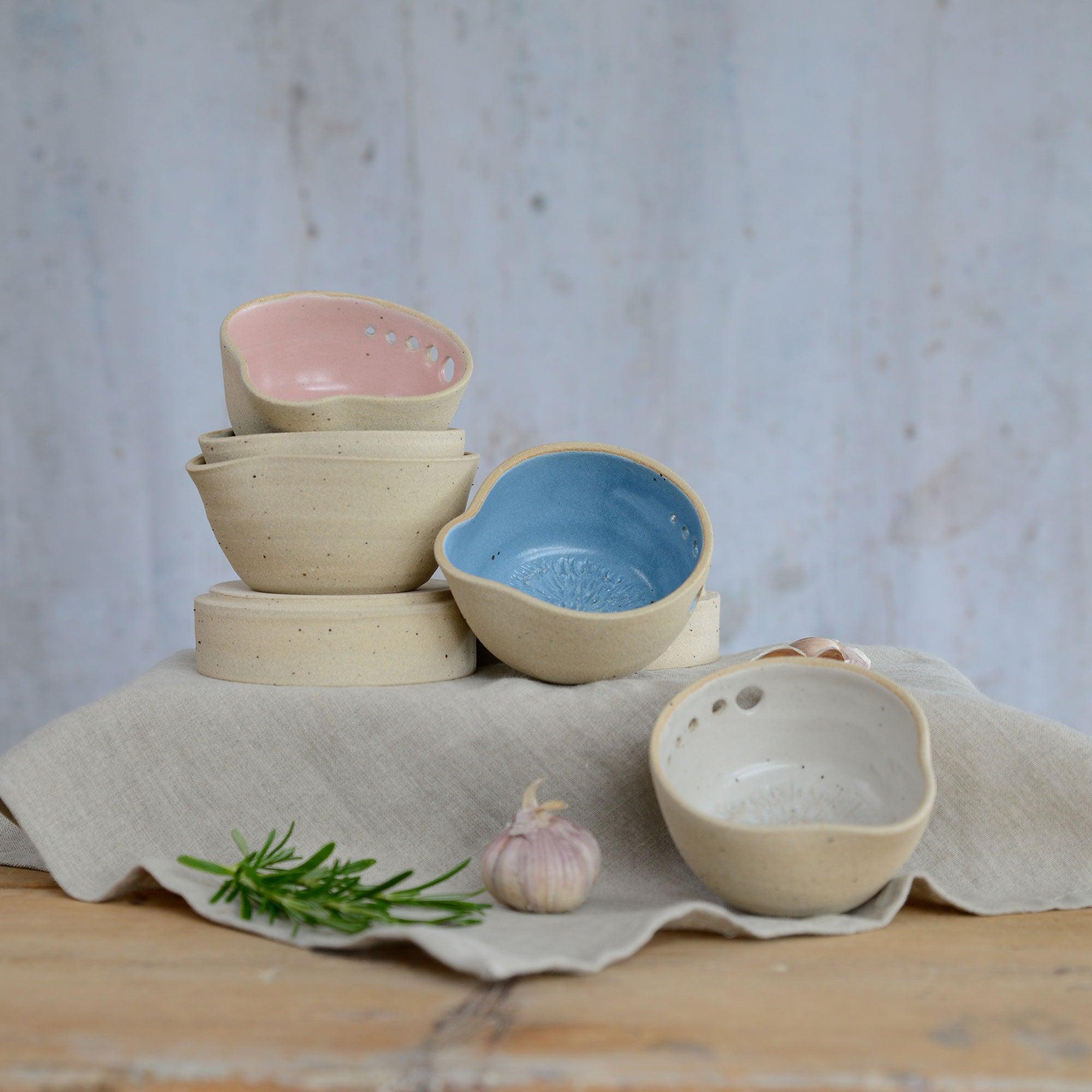 Stacked pastel herb shredder bowls on different levels
