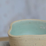 Close up flecked stoneware spout and green glaze