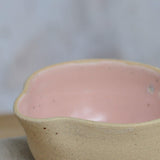 Close up flecked stoneware spout and pink glaze