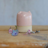 Close up of flecked stoneware and pink glaze on small jug