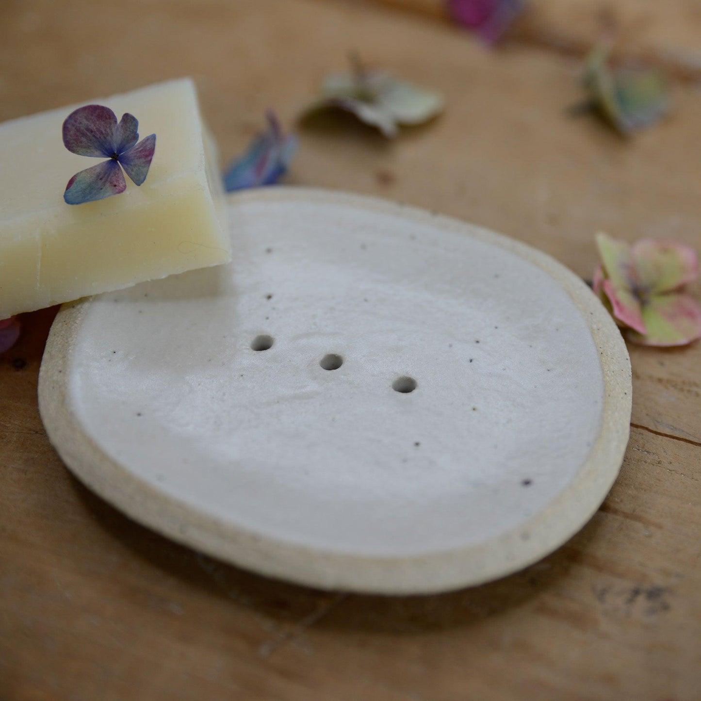 Close up of flecked stoneware and white glaze on soap dish