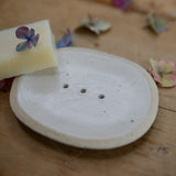 Close up of flecked stoneware and white glaze on soap dish