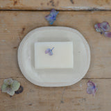 Large white soap dish with soap for size reference
