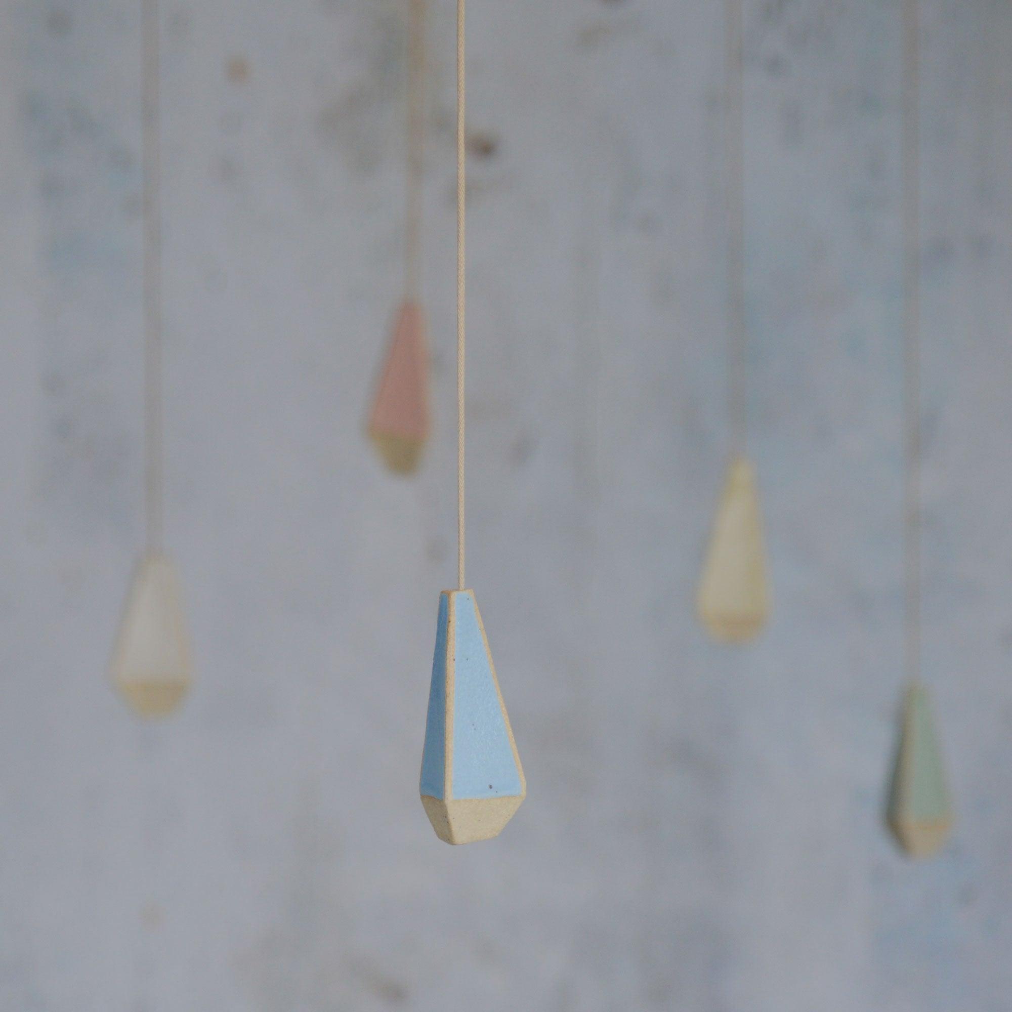 Light pull handles hanging  with blue in focus at the front