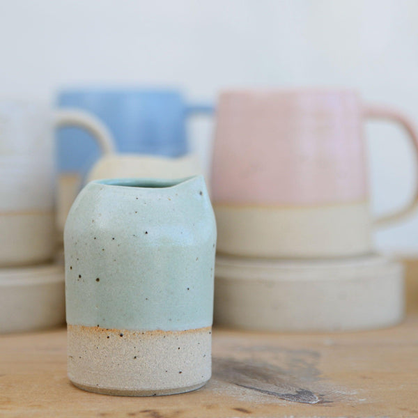 Close up of flecked stoneware and green glaze on small jug