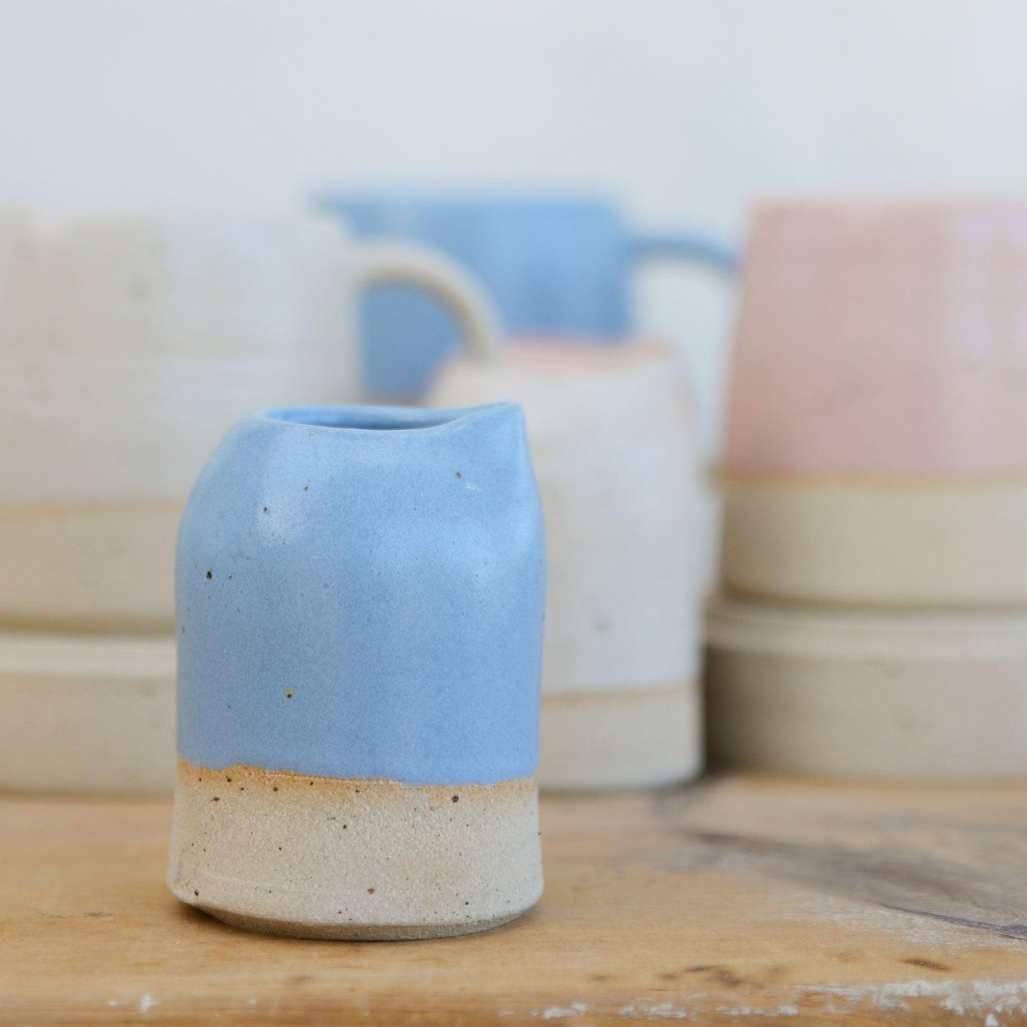 Close up of flecked stoneware and blue glaze on milk jug