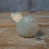 Close up side view of green glaze and stoneware of bird