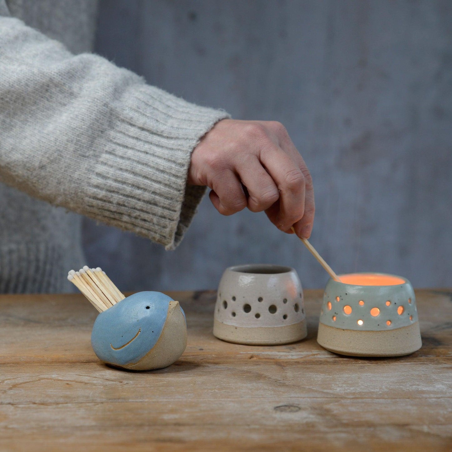 Matches from blue bird match pot being used to light tealight