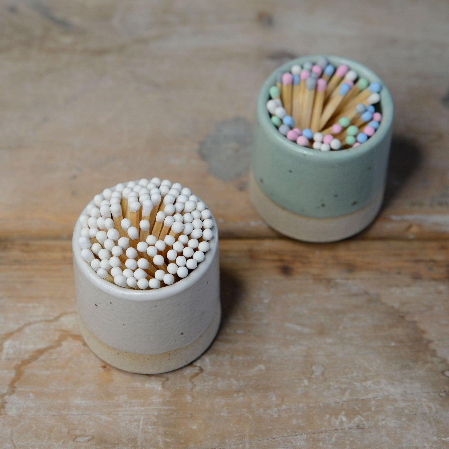 Above view of match pots filled with white and pastel matches
