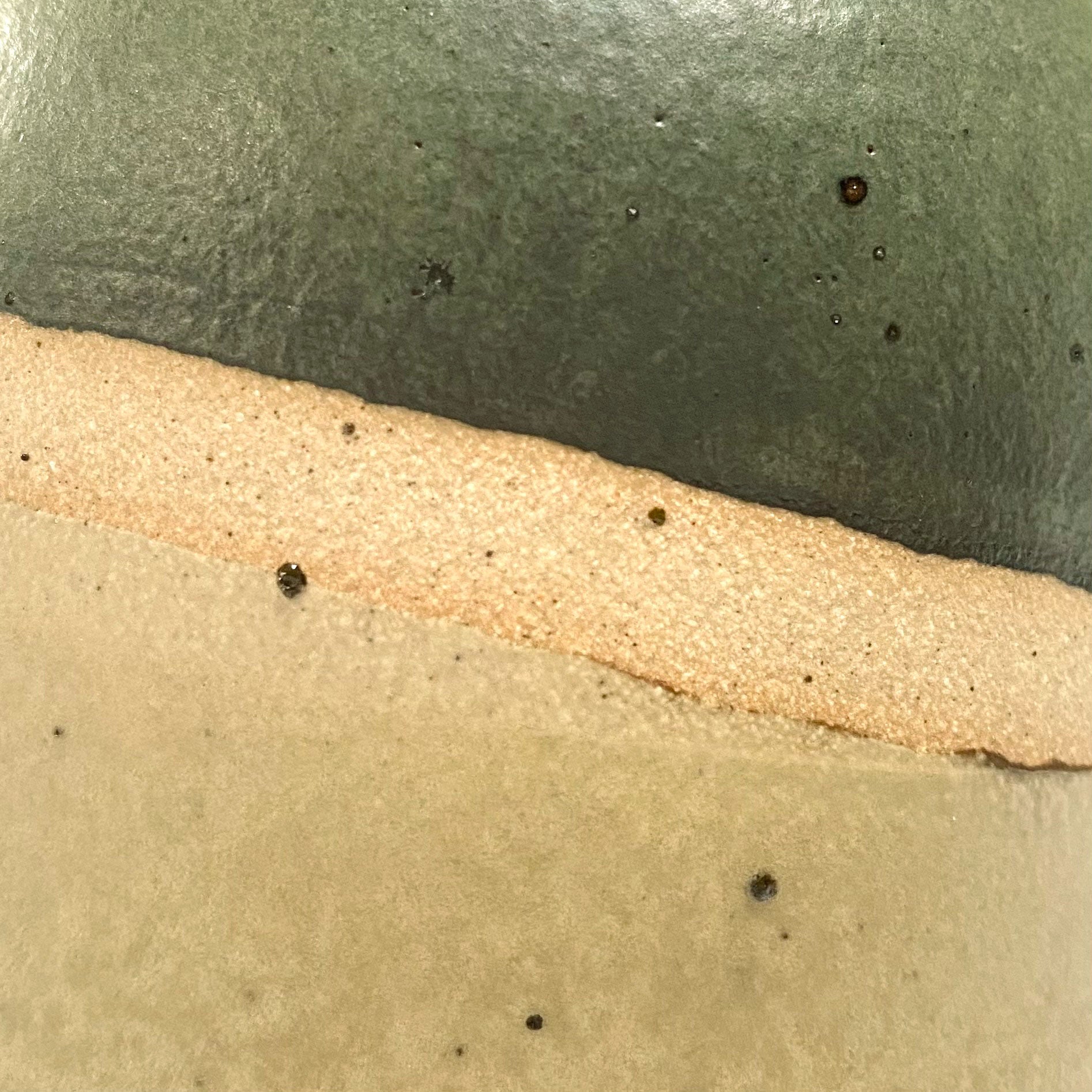 Close up of natural clay flecks showing through the glaze on the pourer