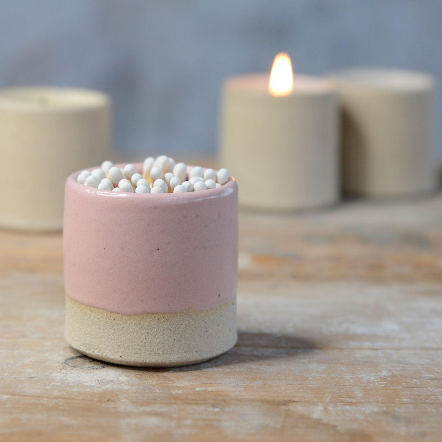 Close up of pink glaze and stoneware clay on pot