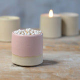 Close up of pink glaze and stoneware clay on pot