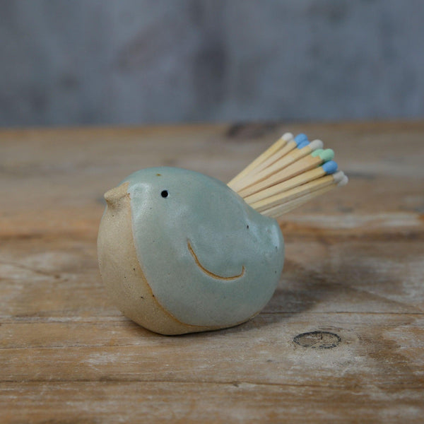 Close up of stoneware and green glaze and matches
