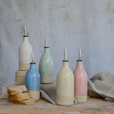 Five pastel large oil pourers on different levels
