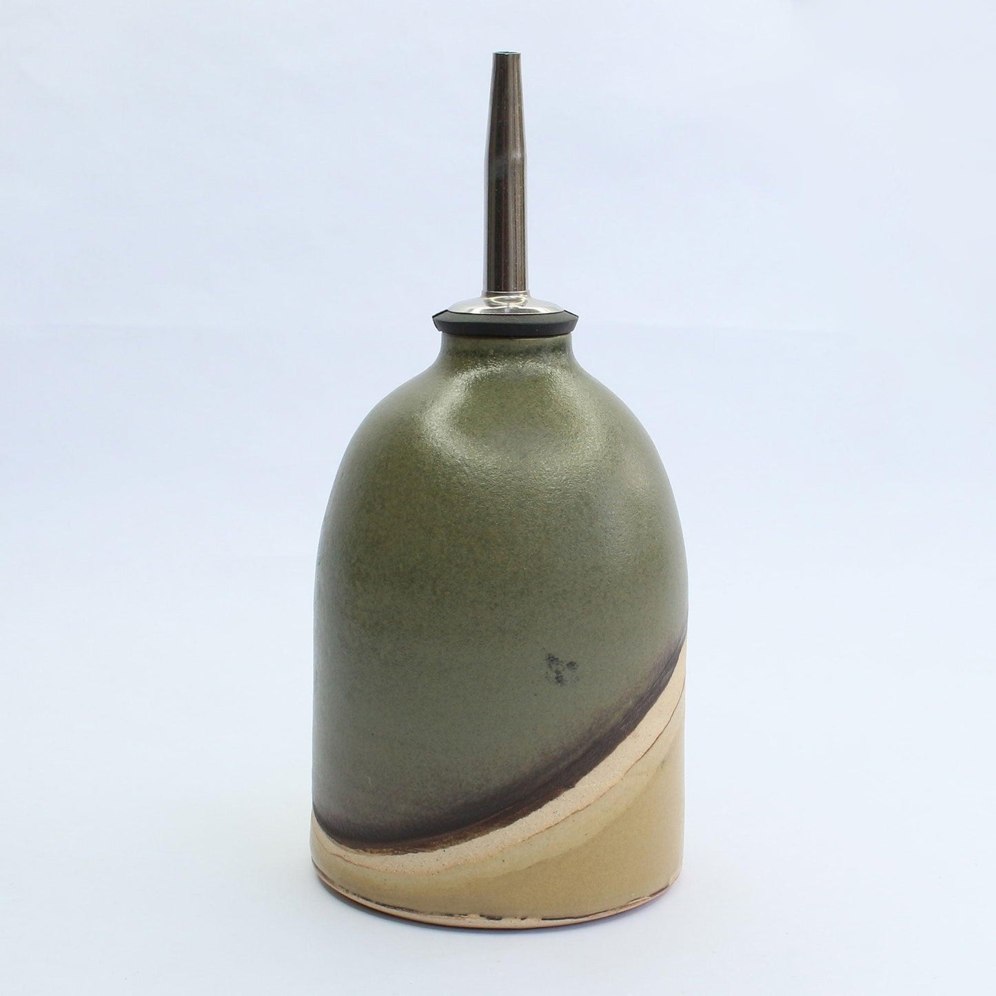 Close up of moorland oil pourer satin green glaze with characteristics