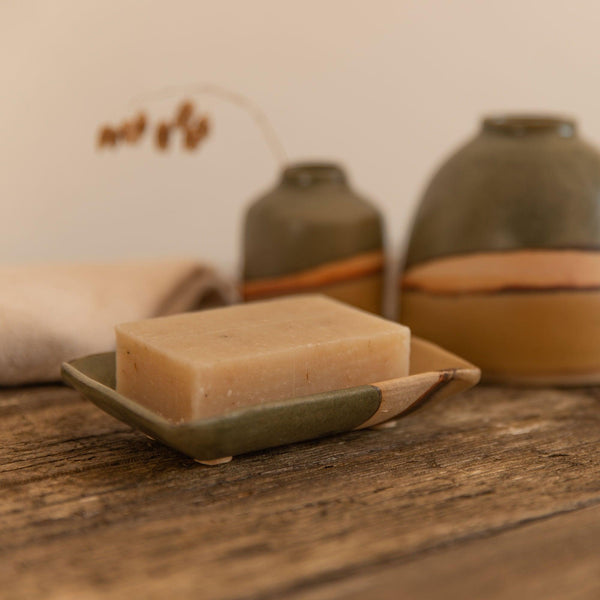 A natural soap bar in the Moorland soap dish next to matching Moorland vases
