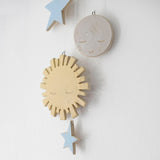 Close up of stoneware yellow sun, white moon and blue stars carvings